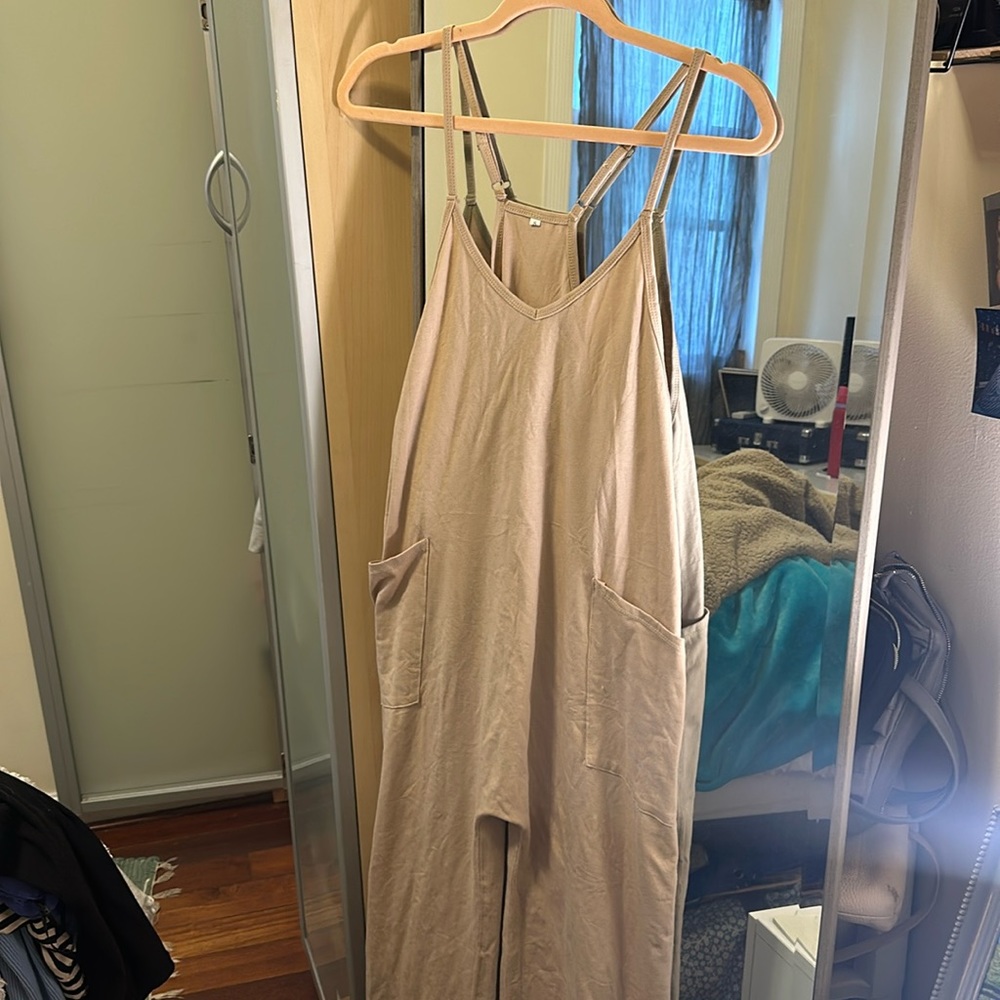 Size small tan, one piece jumpsuit. Over size fit